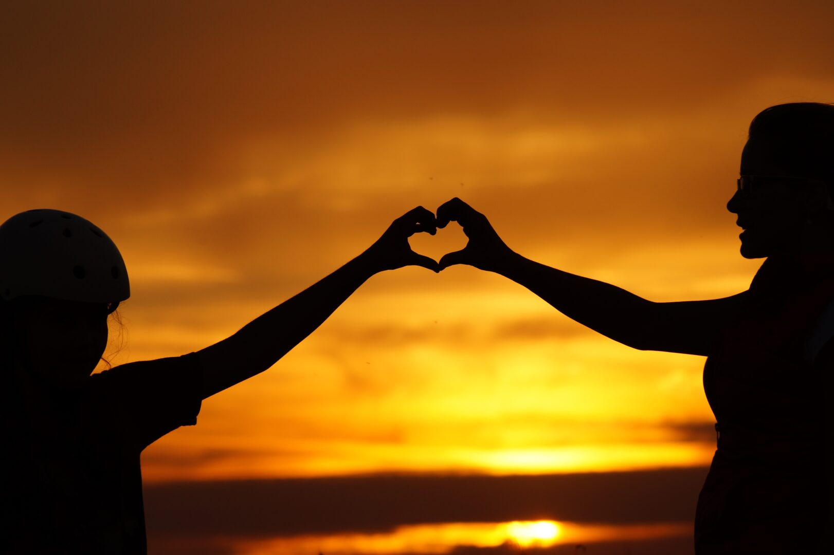 silhouette-of-man-touching-woman-against-sunset-sky-256807